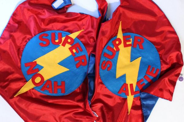 handmade superhero capes in red and blue, personalised with the child's names