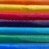 colour samples of all backpack fabrics - red, orange, yellow, pink, purple, turquoise, green, blue, black