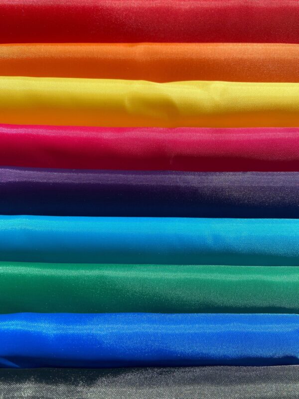 colour samples of all backpack fabrics - red, orange, yellow, pink, purple, turquoise, green, blue, black